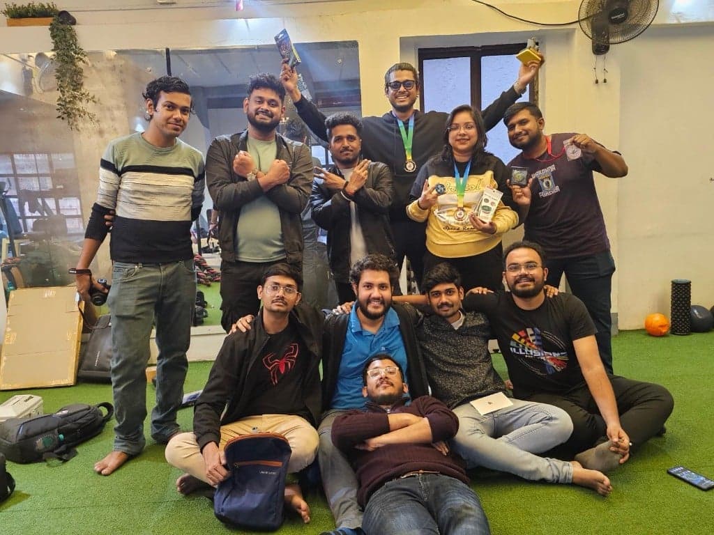 Kolkata Bladers group photo indoors on turf, with medals and prizes after an event